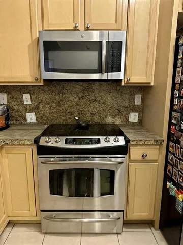 a stove top oven sitting inside of a kitchen