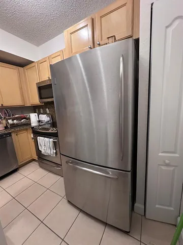 a refrigerator freezer sitting in a kitchen