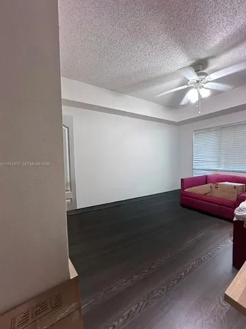 a living room with a couch and a ceiling fan