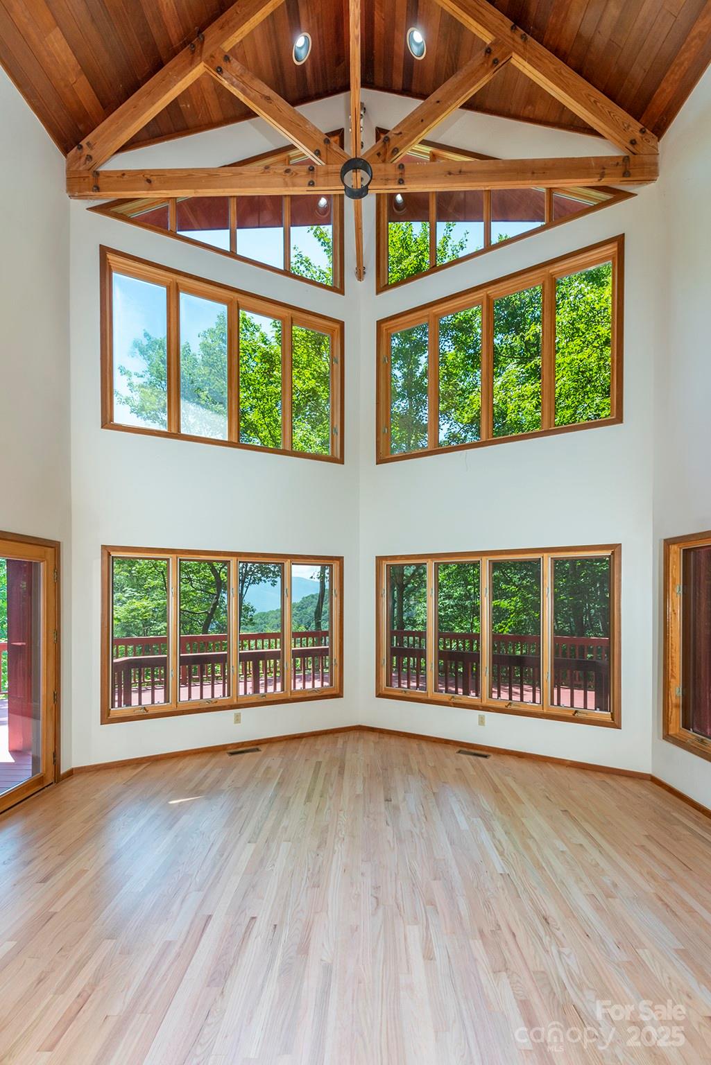 7 Winding Poplar Road Black Mountain, NC 28711 - Photo 14 of 48 a view of an empty room with wooden floor and a floor to ceiling window
