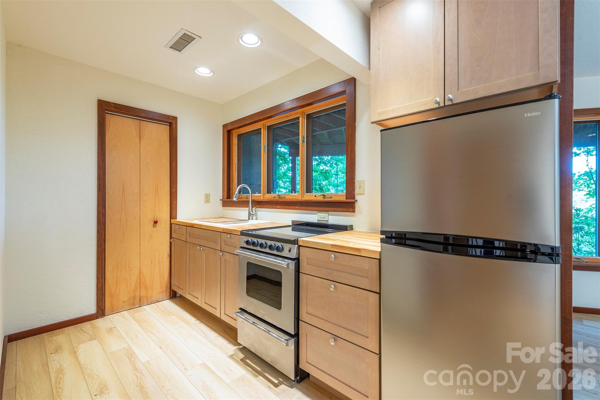 7 Winding Poplar Road Black Mountain, NC 28711 - Photo 37 of 48 a kitchen with a refrigerator and a stove top oven