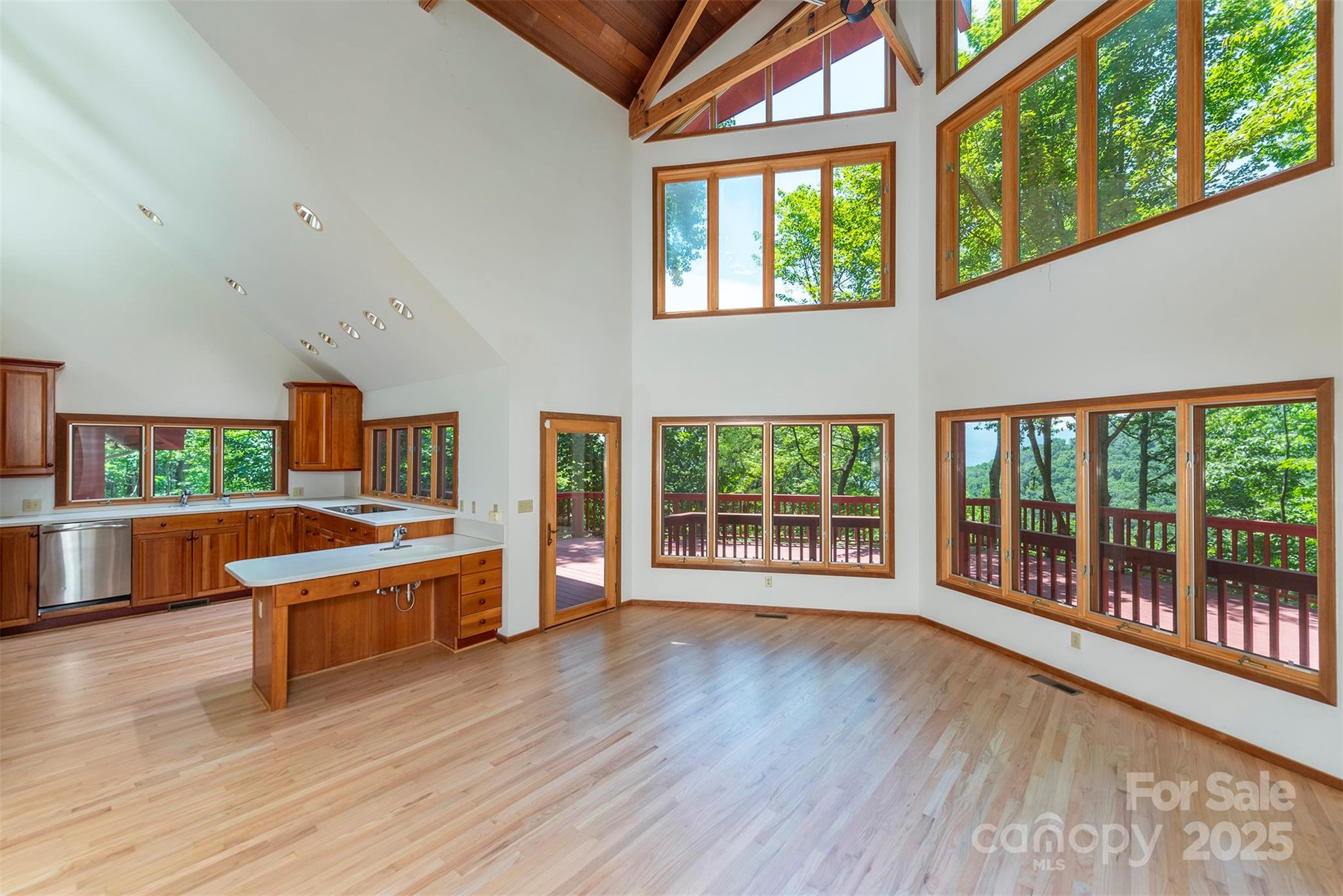 7 Winding Poplar Road Black Mountain, NC 28711 - Photo 9 of 48 a large white kitchen with wooden floor and large windows