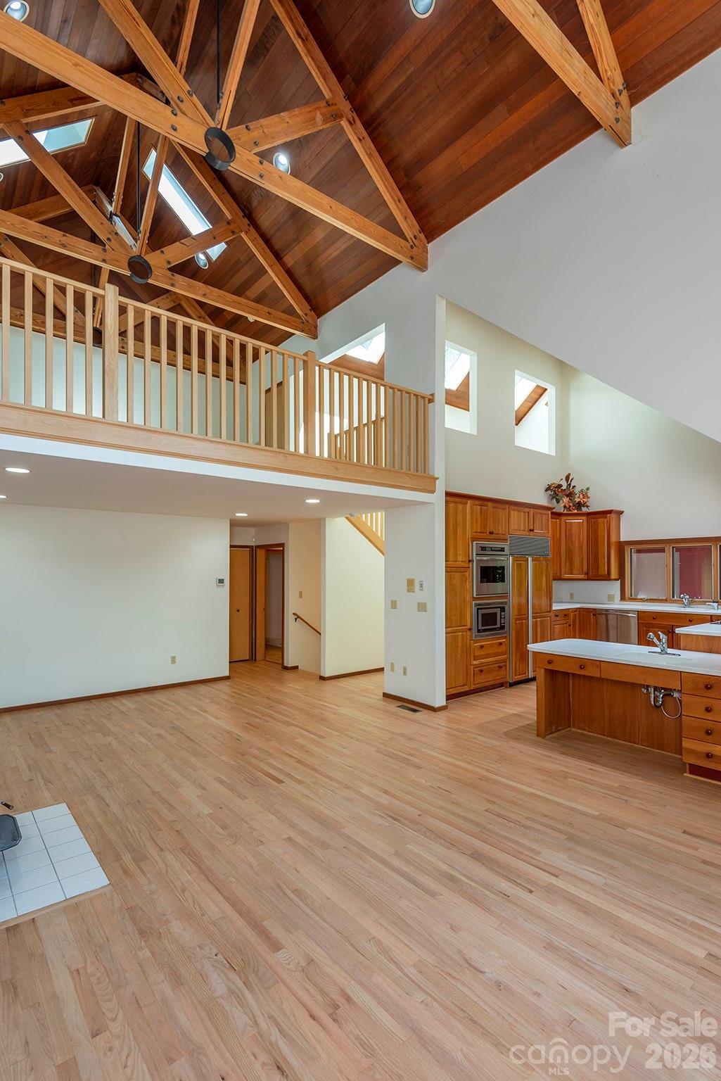 7 Winding Poplar Road Black Mountain, NC 28711 - Photo 10 of 48 a view of an empty room with wooden floor