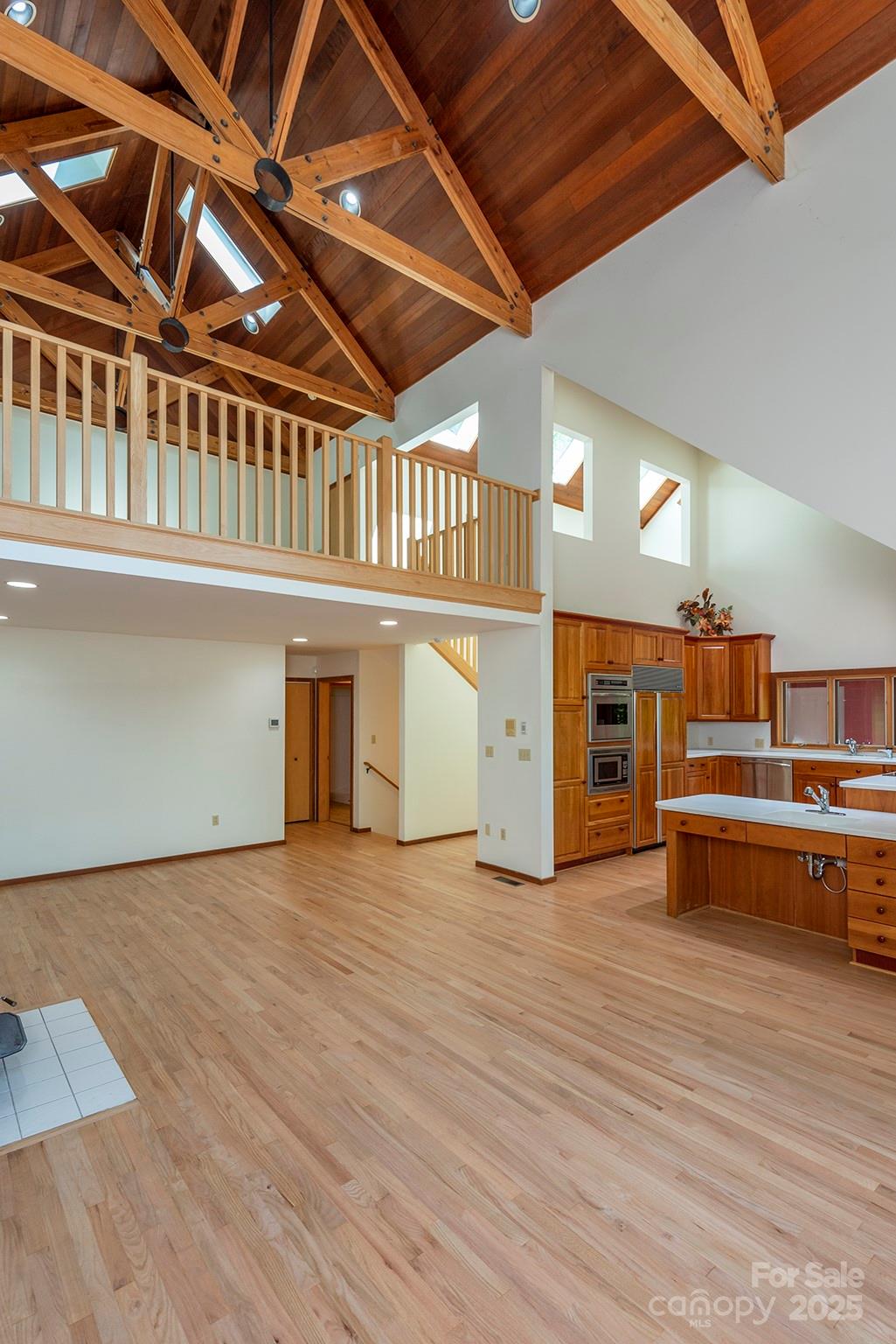 7 Winding Poplar Road Black Mountain, NC 28711 - Photo 10 of 48 a view of an empty room with wooden floor