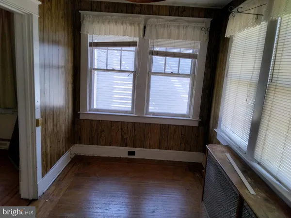 a bathroom with a window and wooden floor