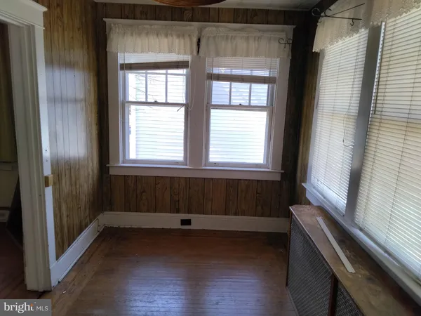 a bathroom with a window and wooden floor