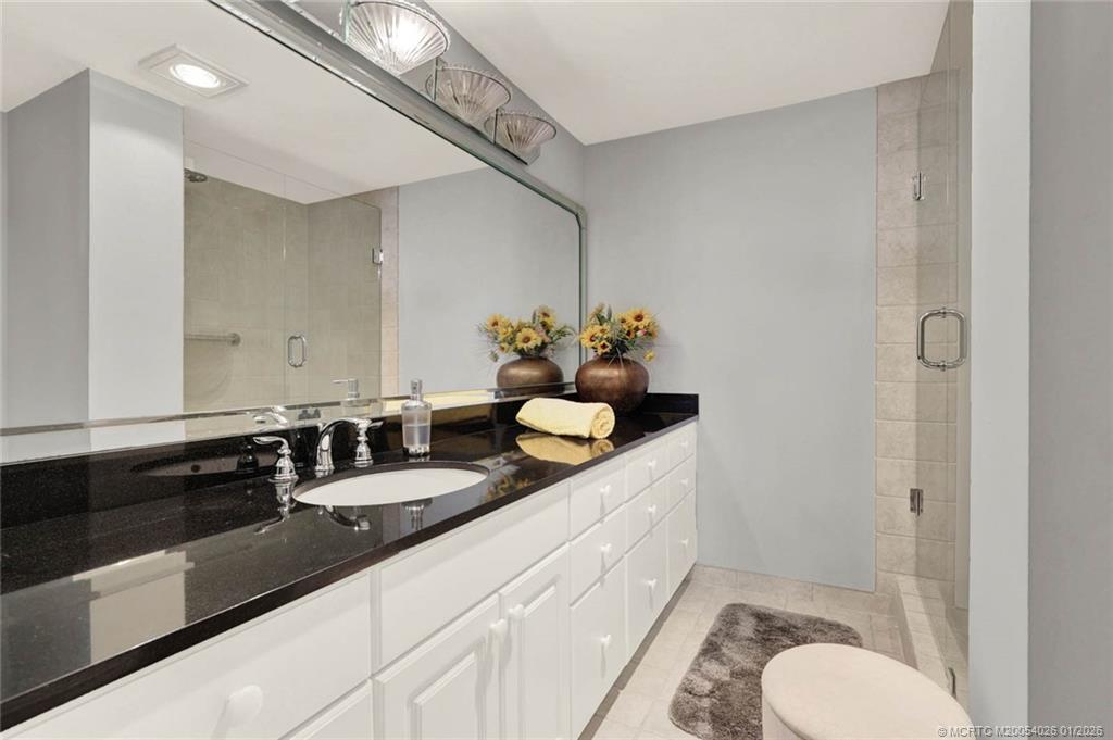 1950 Southwest Palm City Road, Unit 8106 Stuart, FL 34994 - Photo 30 of 54 a bathroom with a granite countertop sink a toilet and a mirror