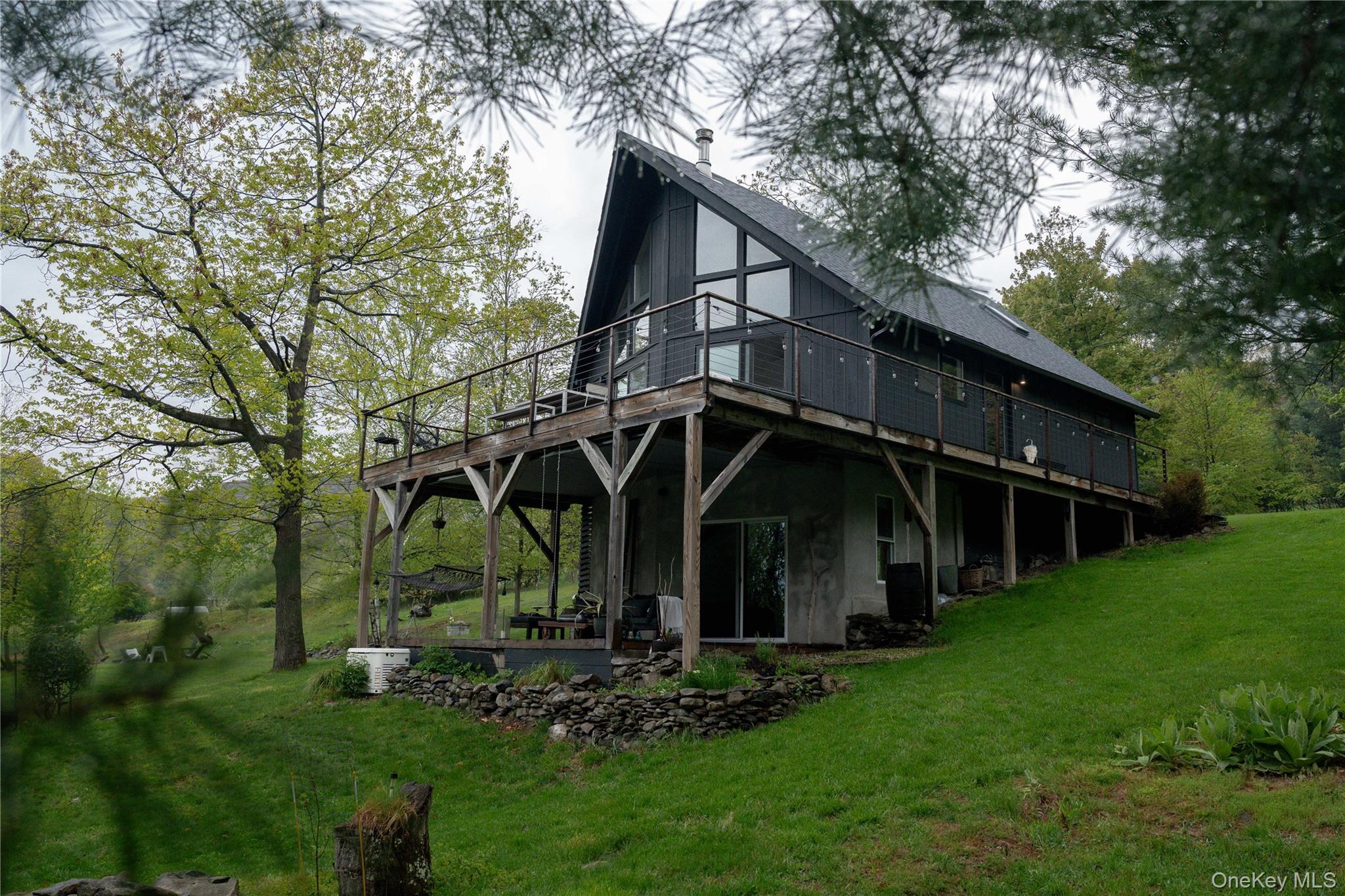 22 Mc Guffey Road Kerhonkson, NY 12446 - Photo 24 of 24 a view of a wooden house with a big yard and large trees