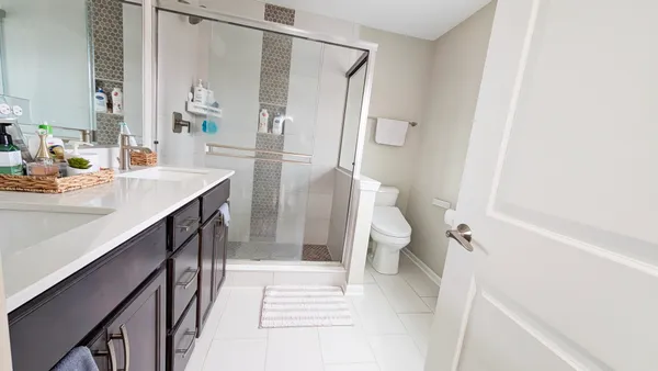 a bathroom with a sink a toilet and a shower