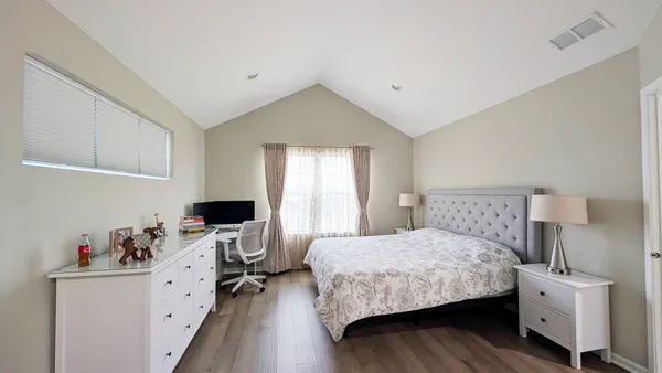 a bedroom with a bed and a view of kitchen