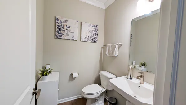 a white toilet sitting next to a bathroom sink