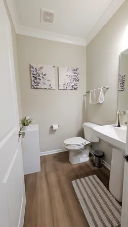 a bathroom with a sink toilet and a mirror