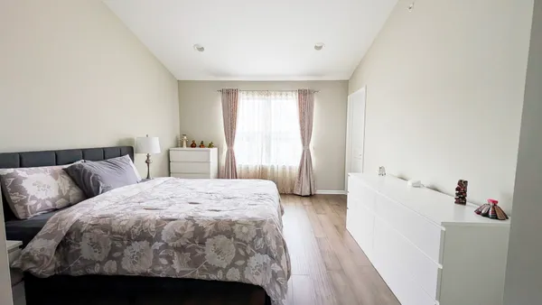 a spacious bedroom with a bed and a window