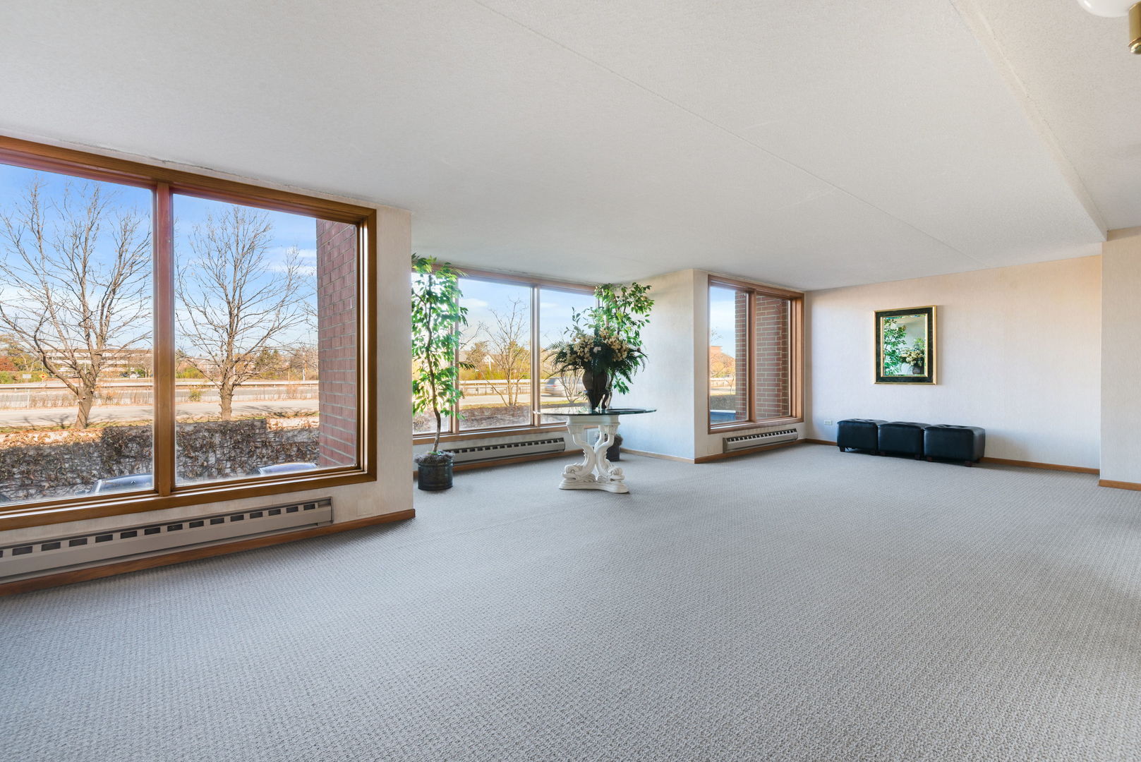 1S095 Spring Road, Unit 1D Oakbrook Terrace, IL 60181 - Photo 18 of 26 a view of an empty room with a fireplace and large windows