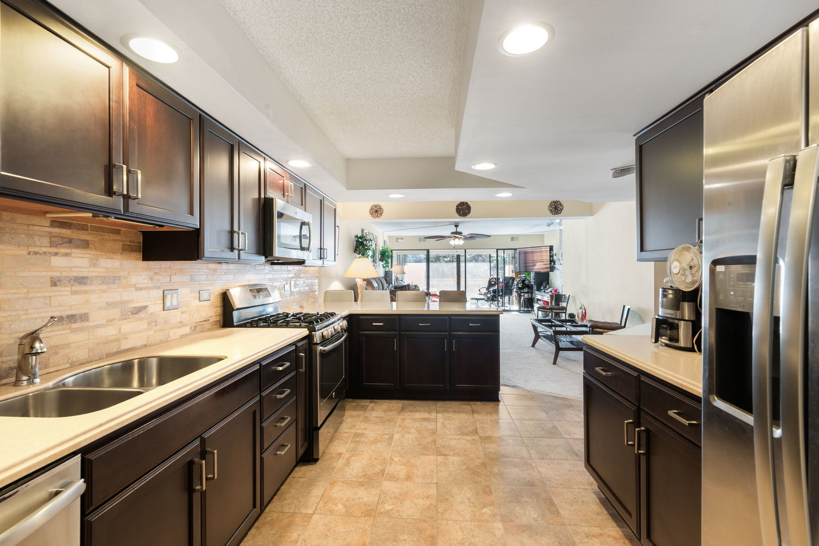 1S095 Spring Road, Unit 1D Oakbrook Terrace, IL 60181 - Photo 2 of 26 a large kitchen with a large counter top appliances and cabinets