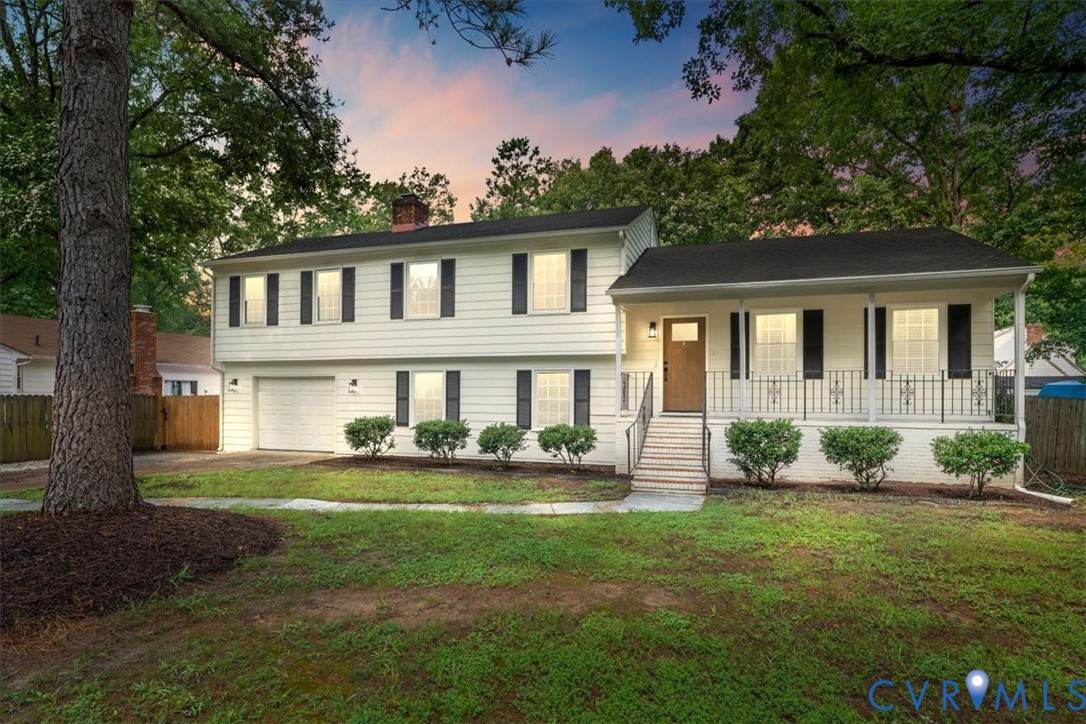 Split-level residence featuring a covered front po