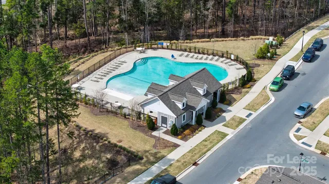 an aerial view of a house with a swimming pool