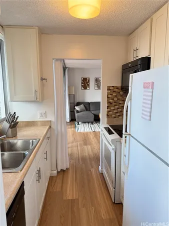 a kitchen with a sink and a refrigerator