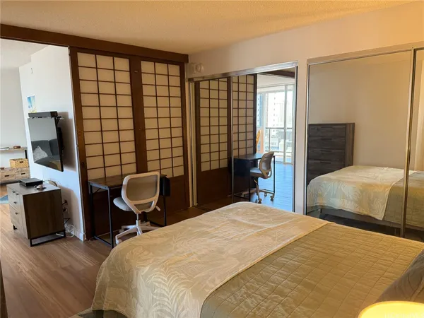 a bedroom with a bed chair and a large window