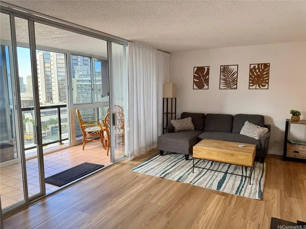a living room with furniture and a wooden floor