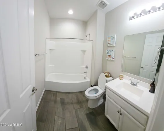 a view of staircase with railing and white walls