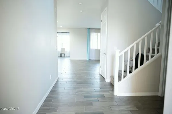 a view of a hallway with wooden floor and staircase