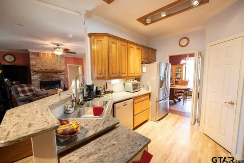 a kitchen with stainless steel appliances granite countertop a sink dishwasher stove and refrigerator