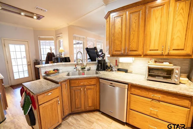 a kitchen with a sink stove and cabinets