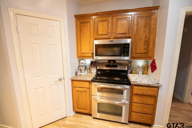 a kitchen with a refrigerator stove and microwave