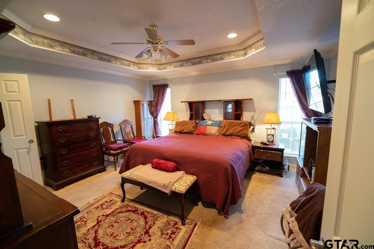 19757-c R 444 C R 444 Lindale, TX 75771 - Photo 19 of 34 a bedroom with a bed and a chandelier