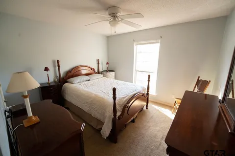 a bedroom with bed and window