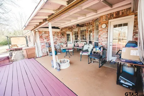 a view of a patio with table and chairs and wooden floor
