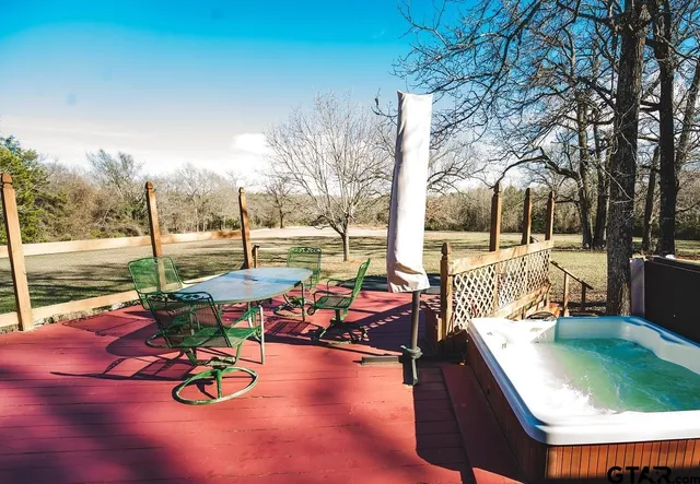 a view of a swimming pool with a patio and a yard