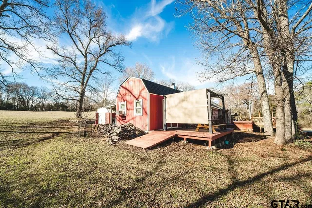 a backyard of a house with table and chairs