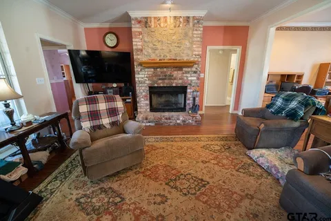 a living room with furniture a flat screen tv and a fireplace