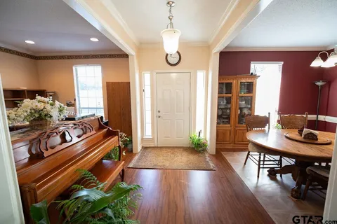 a very nice looking room with wooden floor and furniture