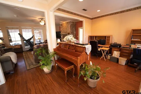 a living room with furniture fireplace and wooden floor