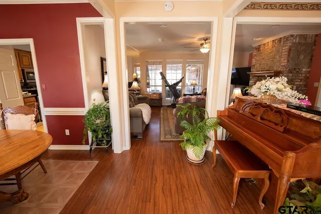 a room with wooden floor table and chairs