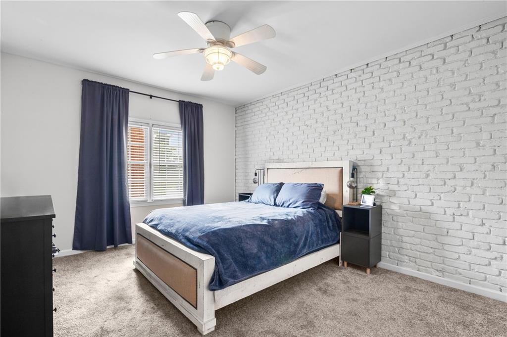 3675 Peachtree Road Northeast, Unit 45 Atlanta, GA 30319 - Photo 17 of 42 a bedroom with a bed and a ceiling fan