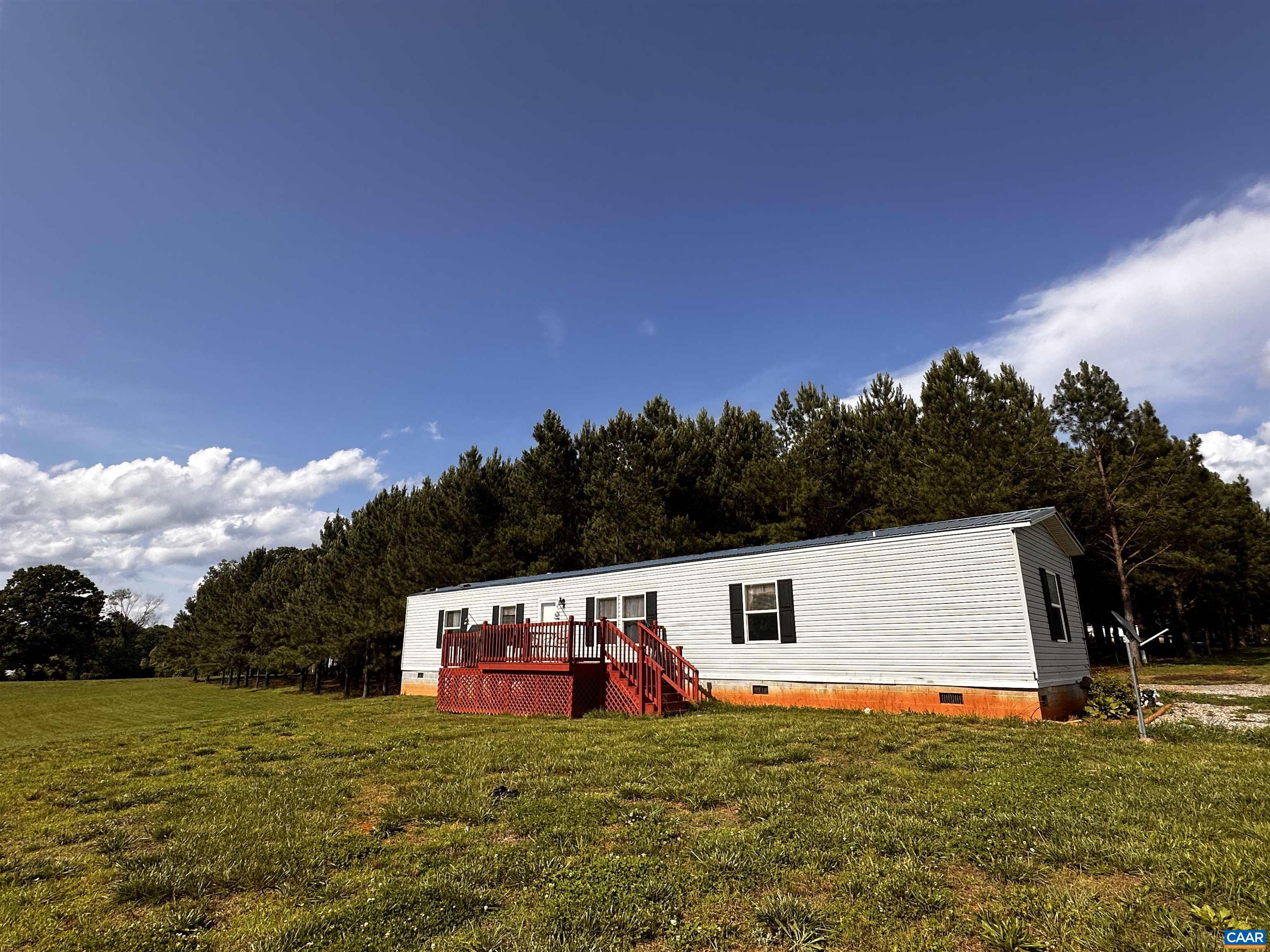 a view of a house with a yard and sitting area