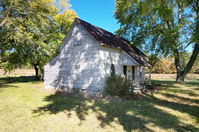 a backyard of a house with yard and outdoor seating