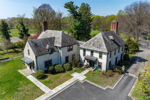 a view of a house with garden and trees