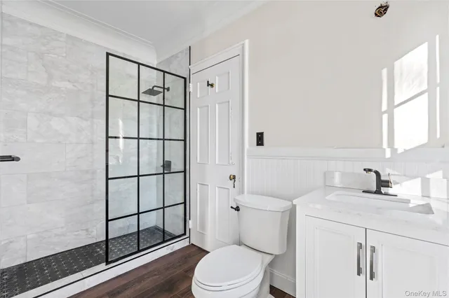 a bathroom with a sink toilet vanity and shower