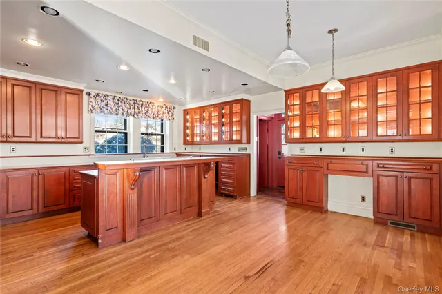 a kitchen with stainless steel appliances granite countertop wooden floors and sink