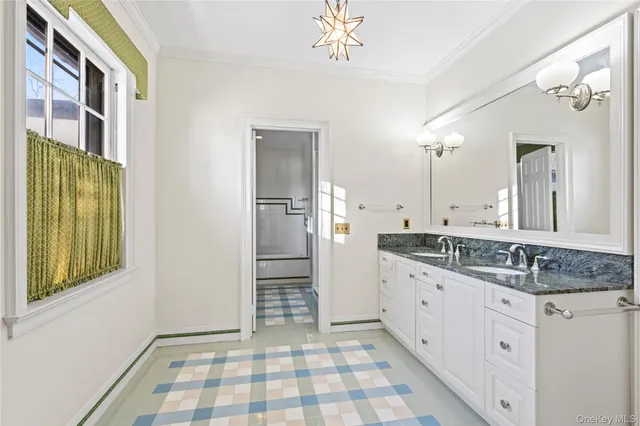 a bathroom with a granite countertop sink a mirror and a shower