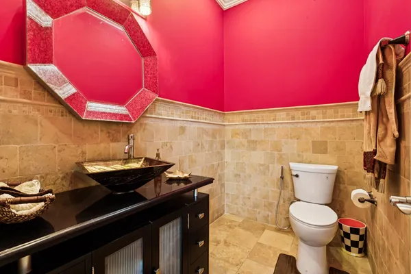 a bathroom with a sink a toilet a mirror and shower curtain