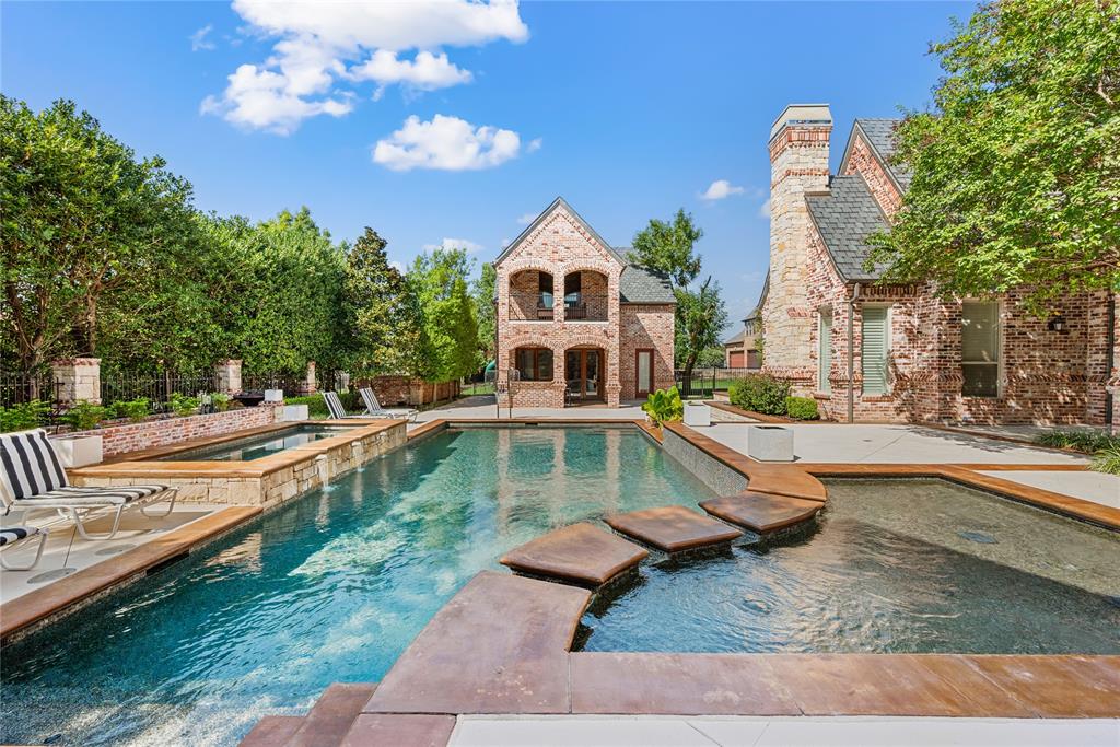 6900 Rockingham Court Colleyville, TX 76034 - Photo 29 of 40 Expansive backyard aquatic area featuring a swimming pool with integrated lighting, a hot tub, baby pool/sunning pool, and fire features.