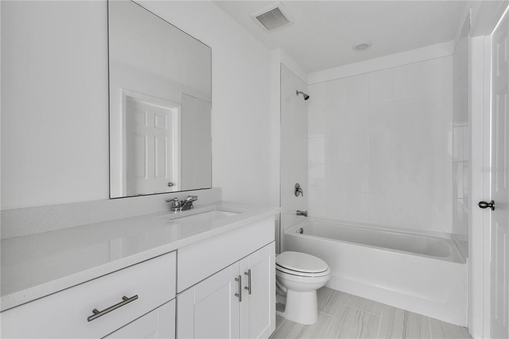 4367 Ranch House Road St. Cloud, FL 34772 - Photo 11 of 29 a bathroom with a sink a toilet and shower