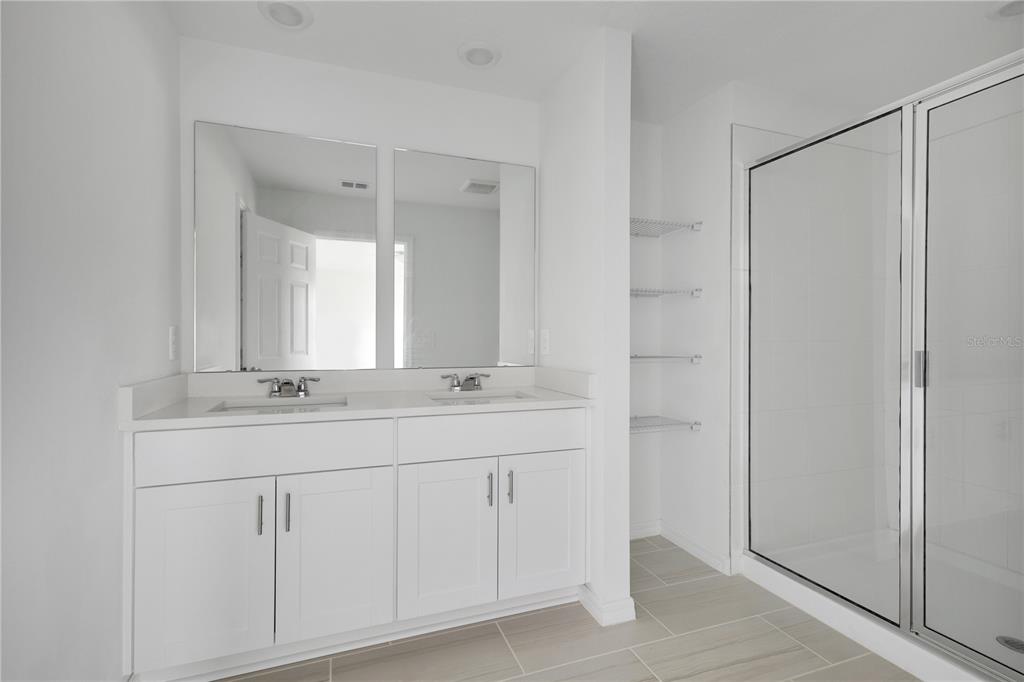 4367 Ranch House Road St. Cloud, FL 34772 - Photo 15 of 29 a bathroom with a double vanity sink and mirror