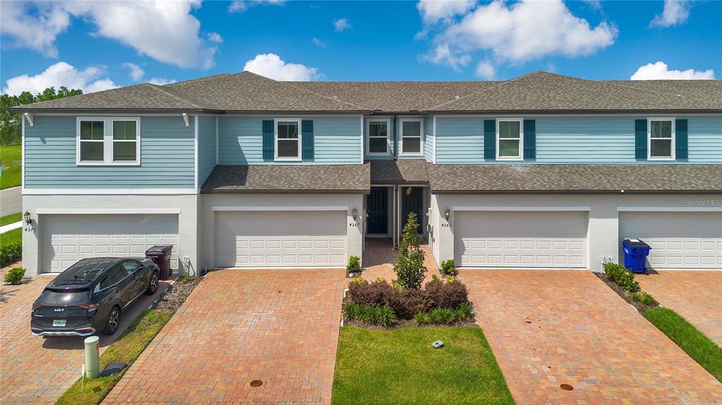 4367 Ranch House Road St. Cloud, FL 34772 - Photo 21 of 29 a front view of a house with a yard and garage